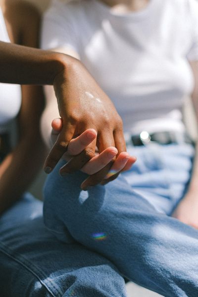 Close up of two women's hands holding 